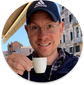 Me wearing a blue baseball cap sipping an espresso